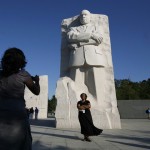 A woman has her picture taken at the new Martin Luther King Jr memorial in Washington