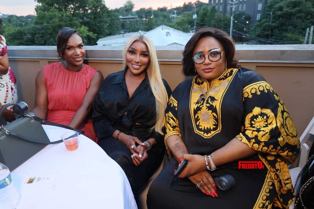 Three women in red, black and patterned dresses posing outdoors at a World Cup 2026 event